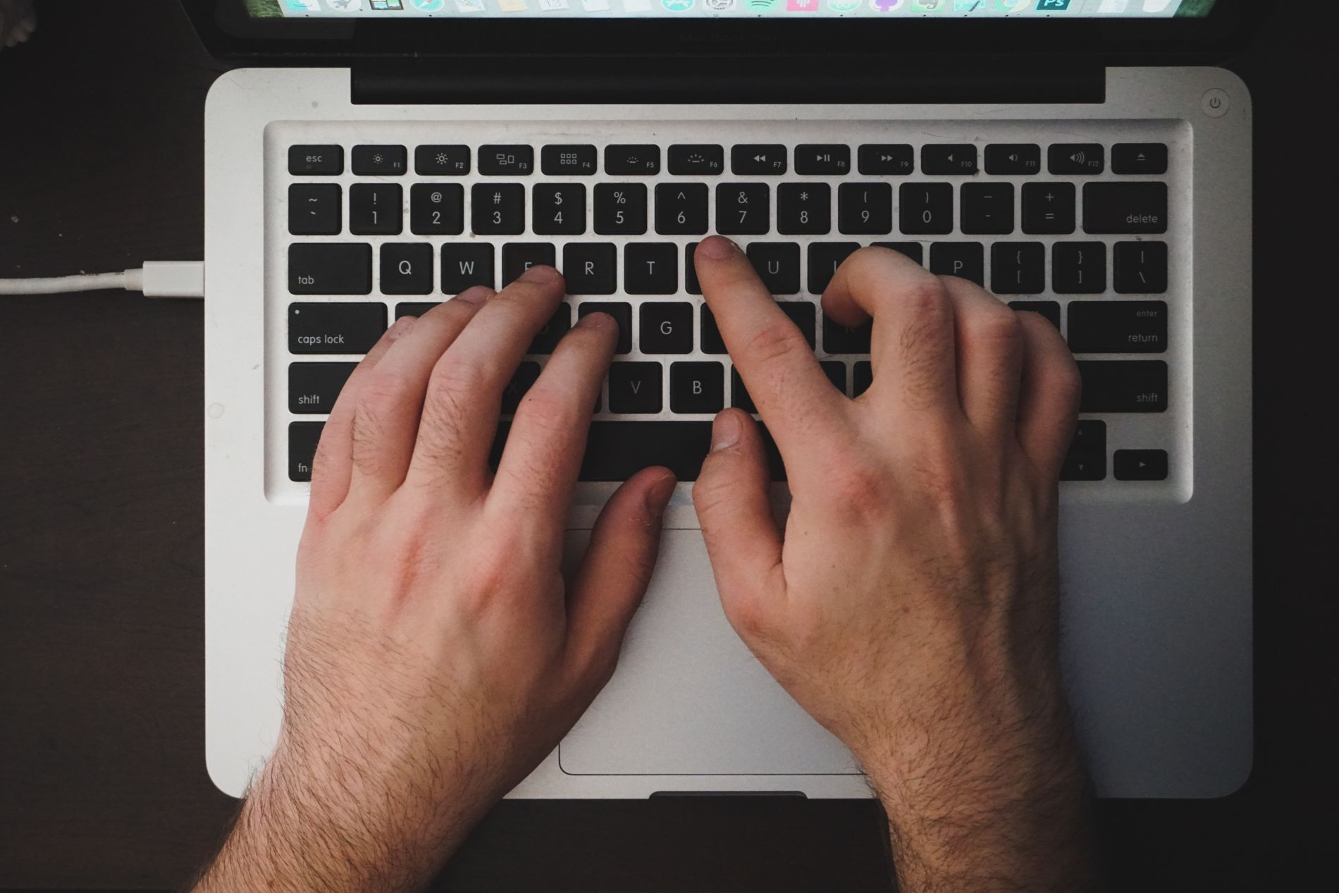 man typing on keyboard